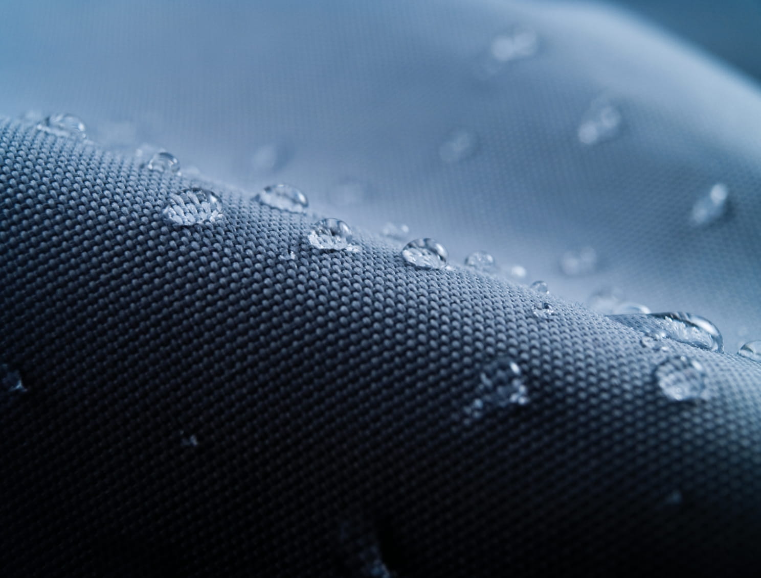 Water-repellent performance fabric by Die Stoffmacher from Baden-Württemberg with water droplets as an example of high-quality outdoor fabrics and custom fabric development.